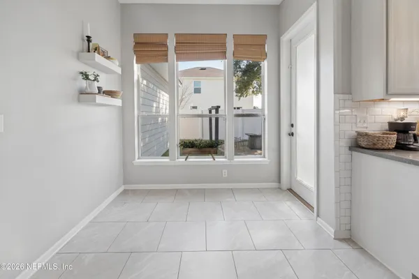 a large white kitchen with cabinets