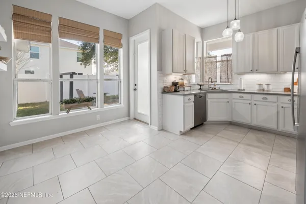 a kitchen with stainless steel appliances a refrigerator sink and cabinets
