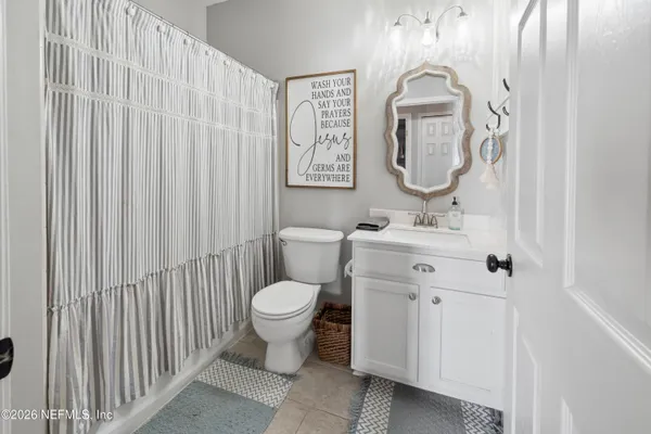 a bathroom with a sink a toilet and mirror