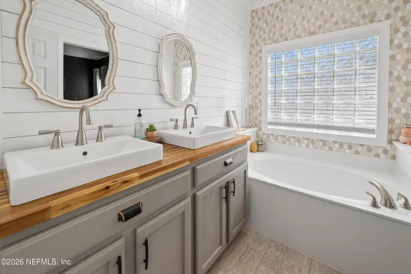 a bathroom with a bathtub and a sink