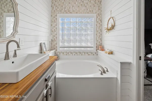 a bathroom with a double vanity sink and mirror