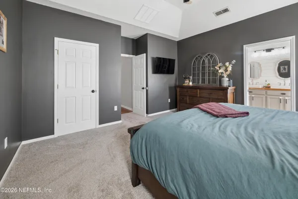 a bedroom with furniture and a window