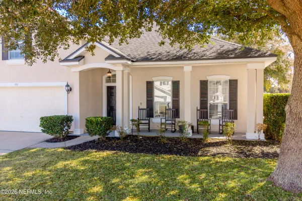 a front view of a house with porch and outdoor seating