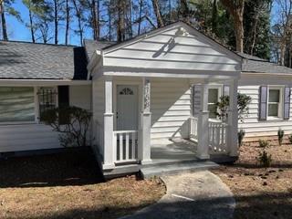 a view of a house with a door and a yard