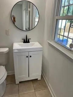 a bathroom with a sink a mirror and a toilet