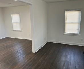 2158 Beecher Road Southwest, Unit A Atlanta, GA 30311 - Photo 7 of 21 an empty room with wooden floor and windows
