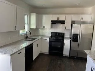 a kitchen with a sink appliances and cabinets