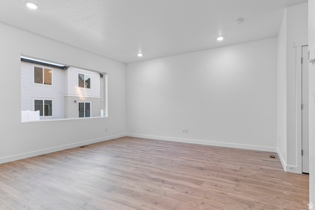 2829 North 710 West, Unit 15 Logan, UT 84321 - Photo 9 of 23 Spacious room featuring wood-finish flooring, recessed lighting, white baseboards, and a large horizontal window