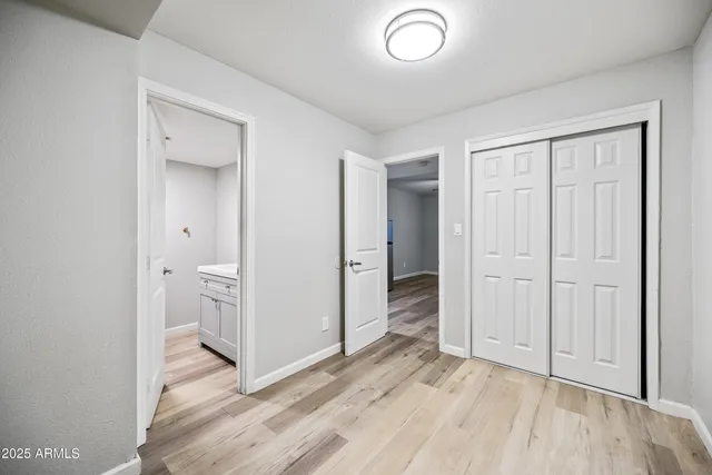 a view of a room with wooden floor and white doors