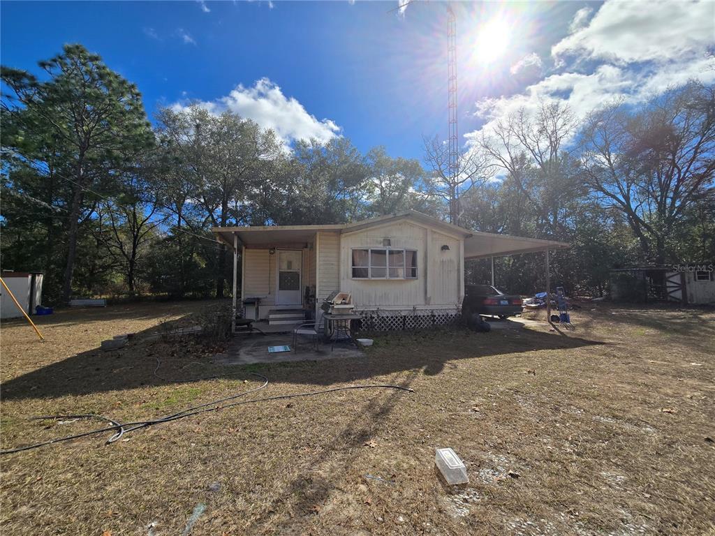 15640 Southwest 3rd Lane Ocala, FL 34481 - Photo 5 of 9 a view of a house with a yard and sitting area
