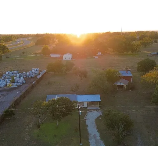an empty room with wooden floor and a bathroom