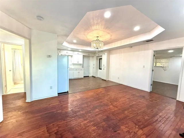 a view of a kitchen with a refrigerator cabinets and wooden floor