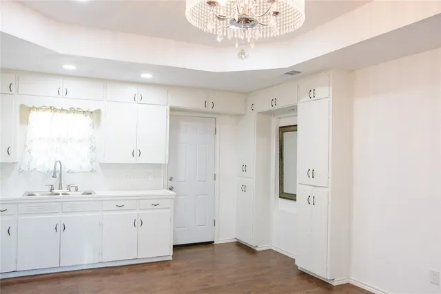a kitchen with white cabinets and white appliances