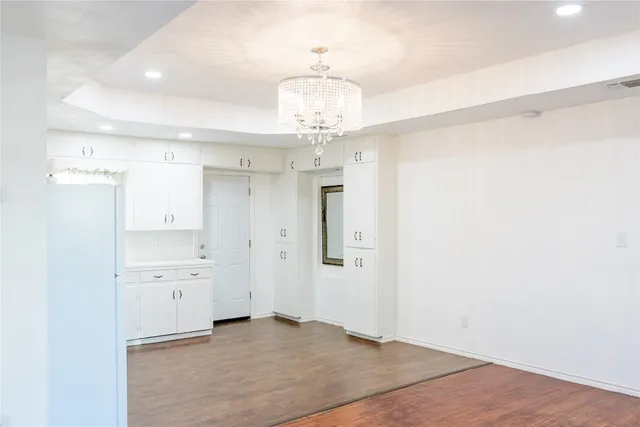 a view of a kitchen with a refrigerator and a stove