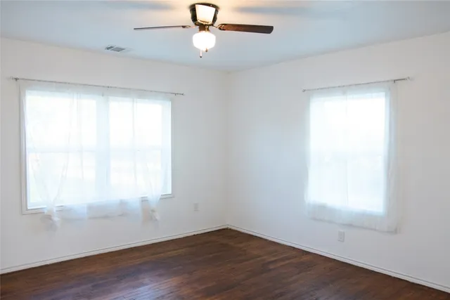 an empty room with wooden floor