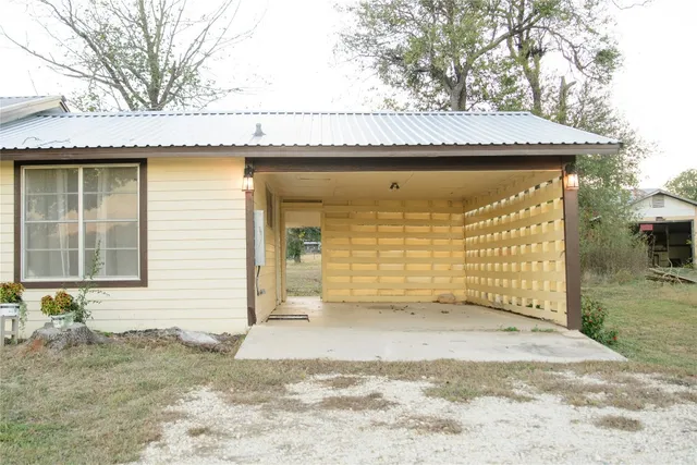 a view of a house with a wooden fence