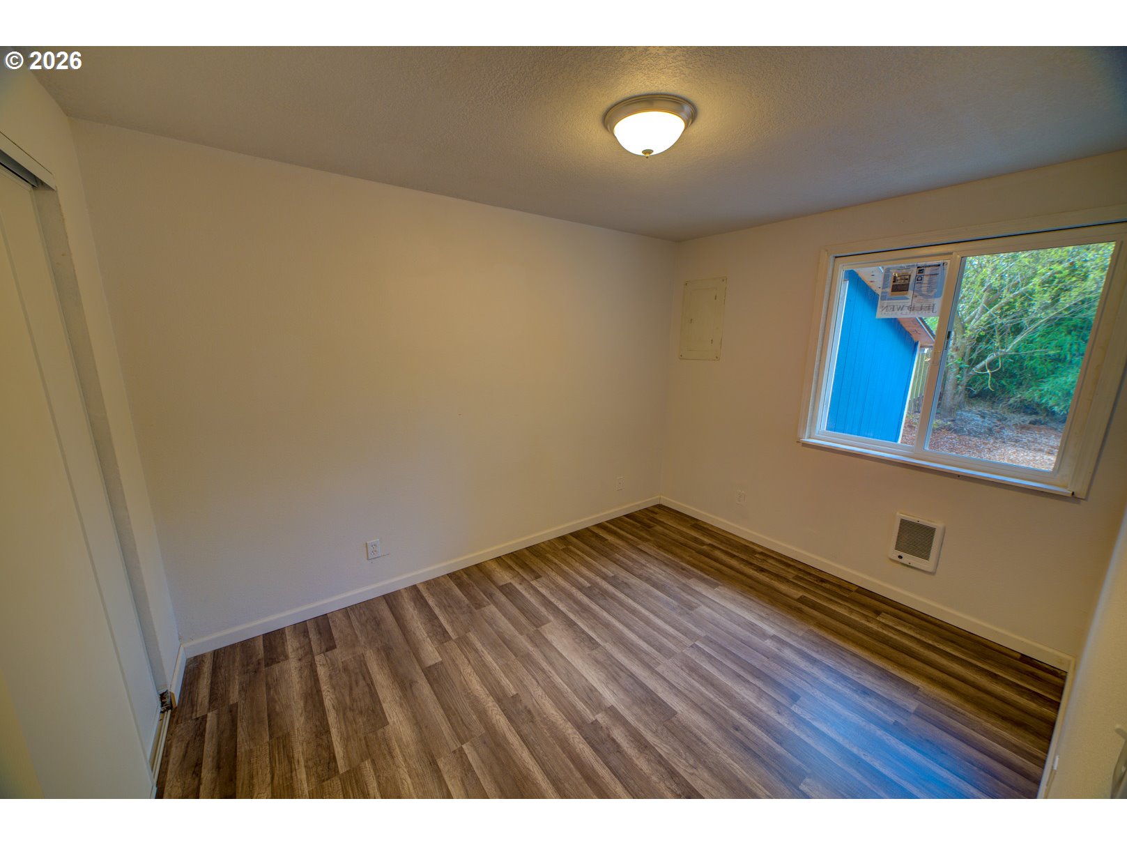 3825 Southwest 198th Avenue Beaverton, OR 97078 - Photo 13 of 23 a view of an empty room with wooden floor and a window