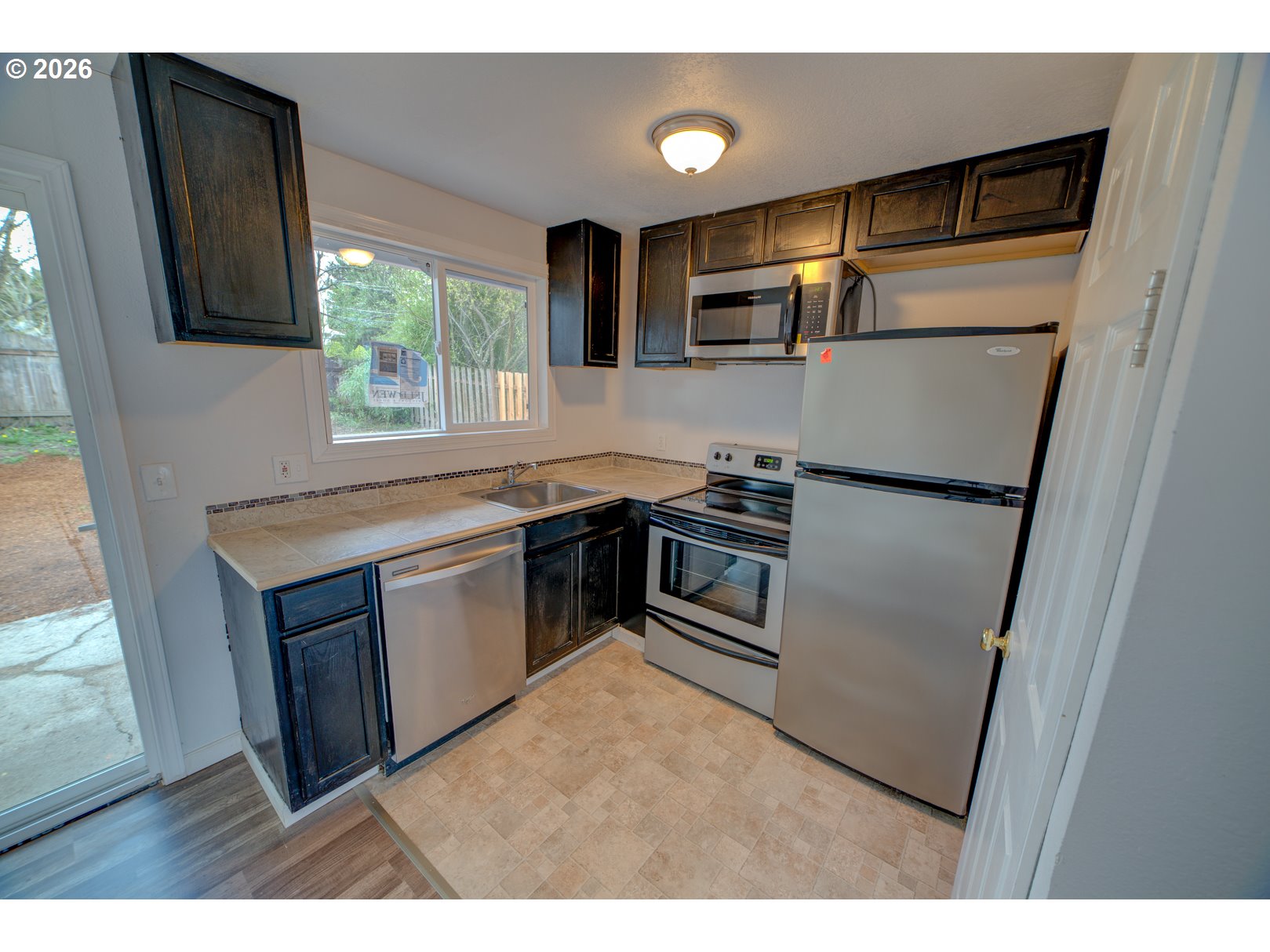 3825 Southwest 198th Avenue Beaverton, OR 97078 - Photo 19 of 23 a kitchen with stainless steel appliances a refrigerator sink and microwave