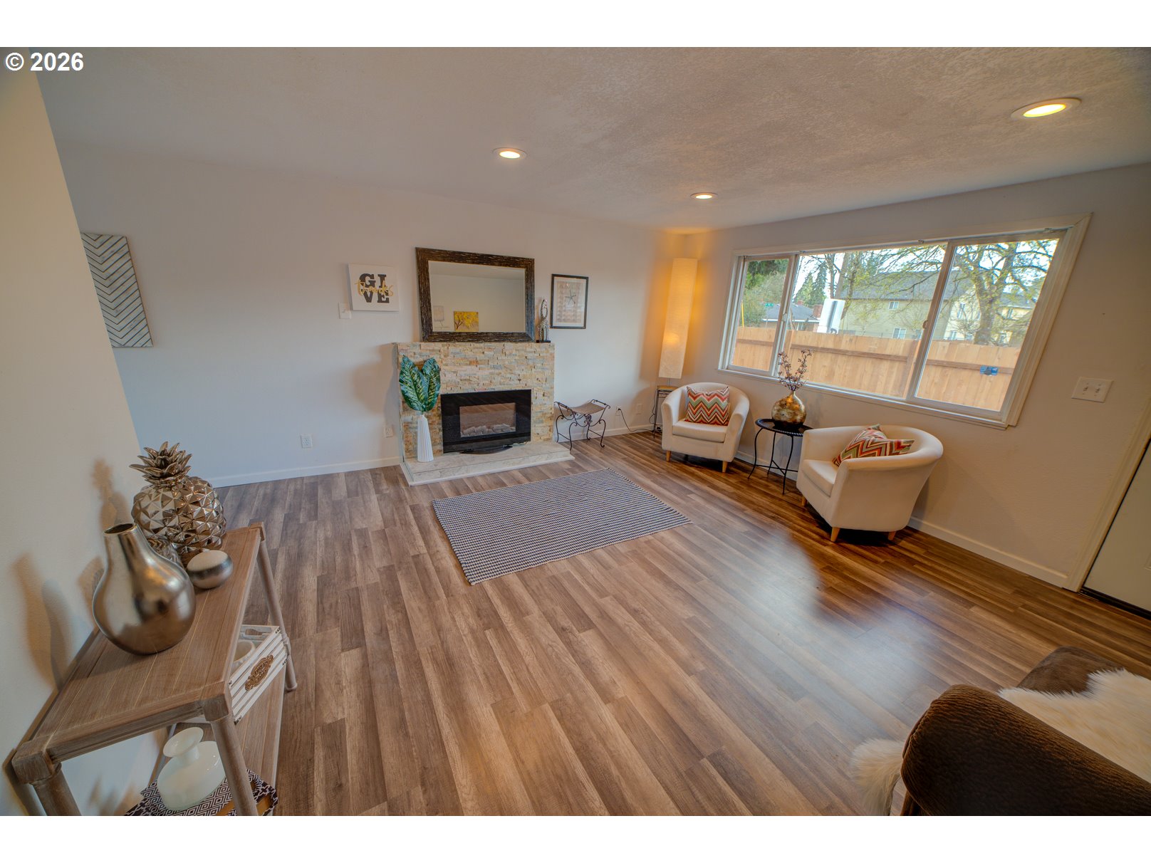 3825 Southwest 198th Avenue Beaverton, OR 97078 - Photo 9 of 23 a living room with furniture and a fireplace