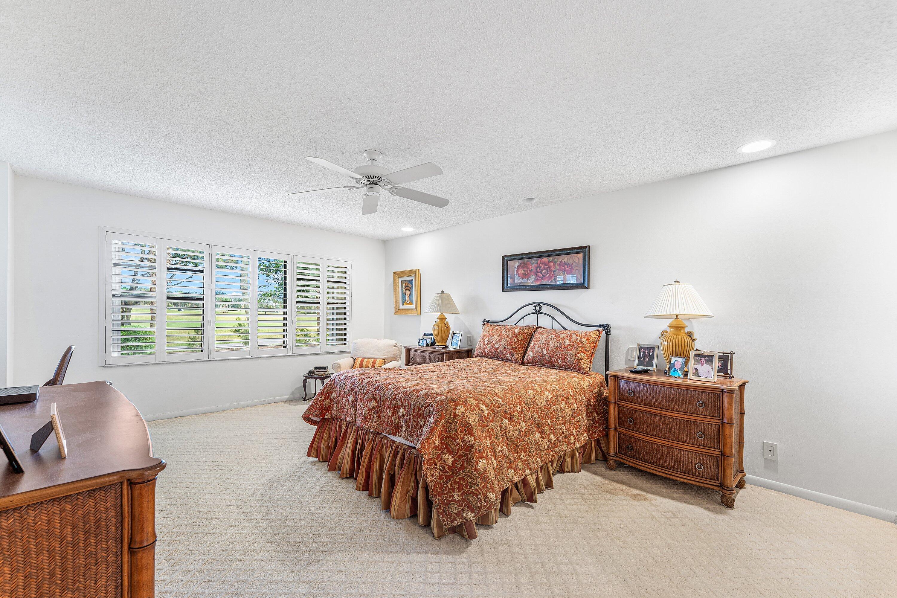 5 Eastgate Drive, Unit A Boynton Beach, FL 33436 - Photo 19 of 49 a bedroom with a bed and furniture