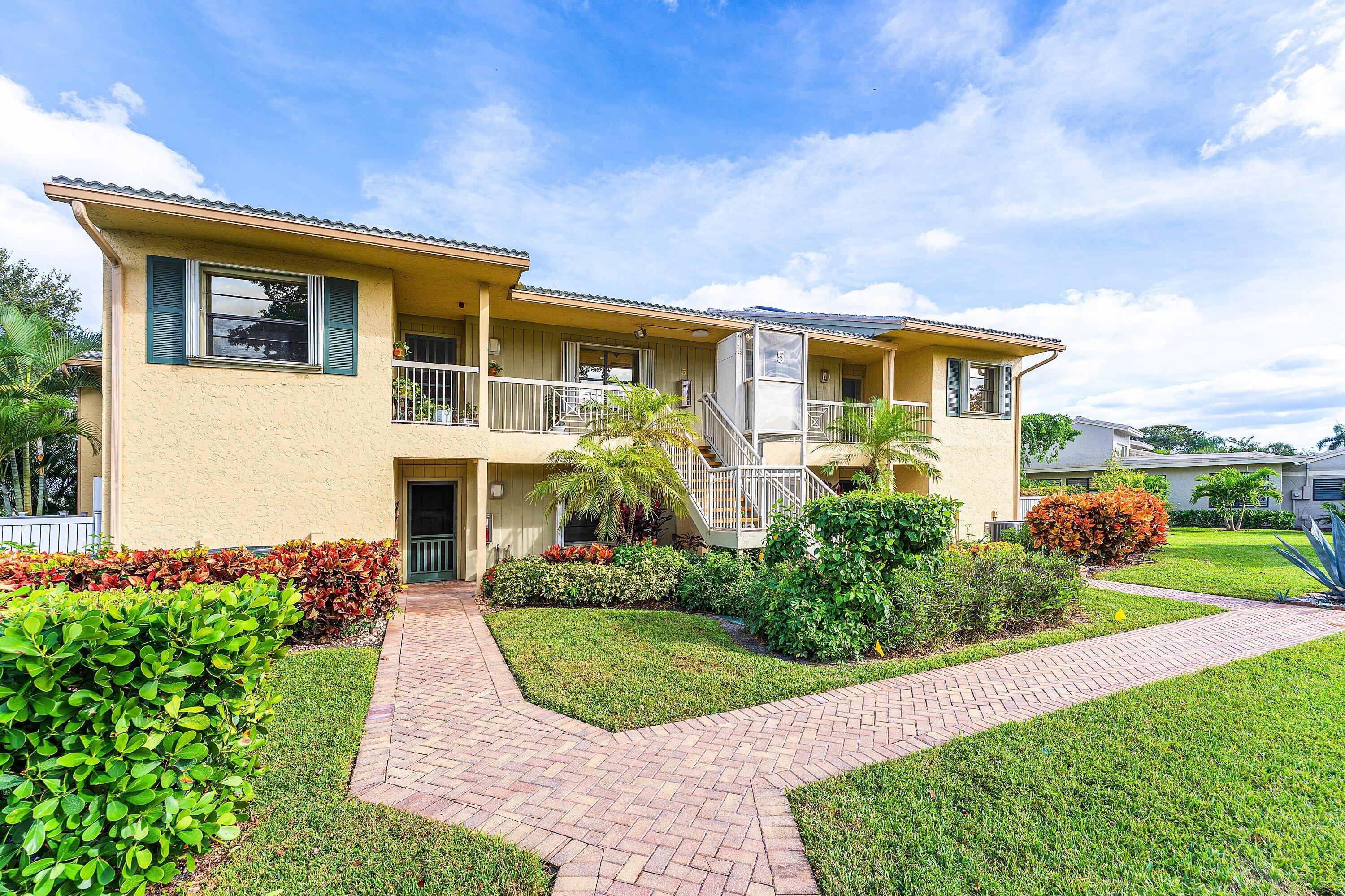 5 Eastgate Drive, Unit A Boynton Beach, FL 33436 - Photo 2 of 49 a front view of a house with a yard