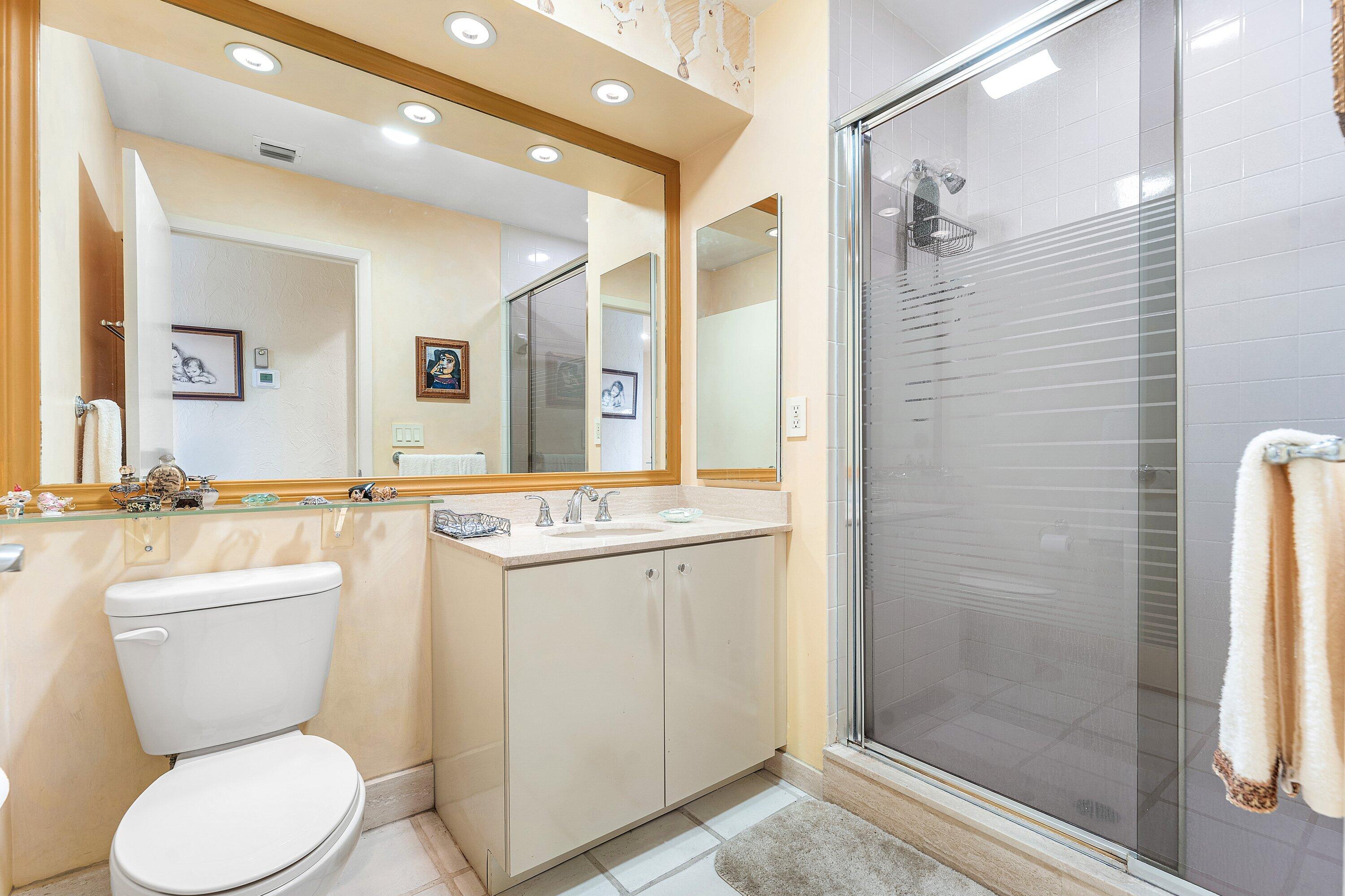 5 Eastgate Drive, Unit A Boynton Beach, FL 33436 - Photo 23 of 49 a bathroom with a toilet sink and shower