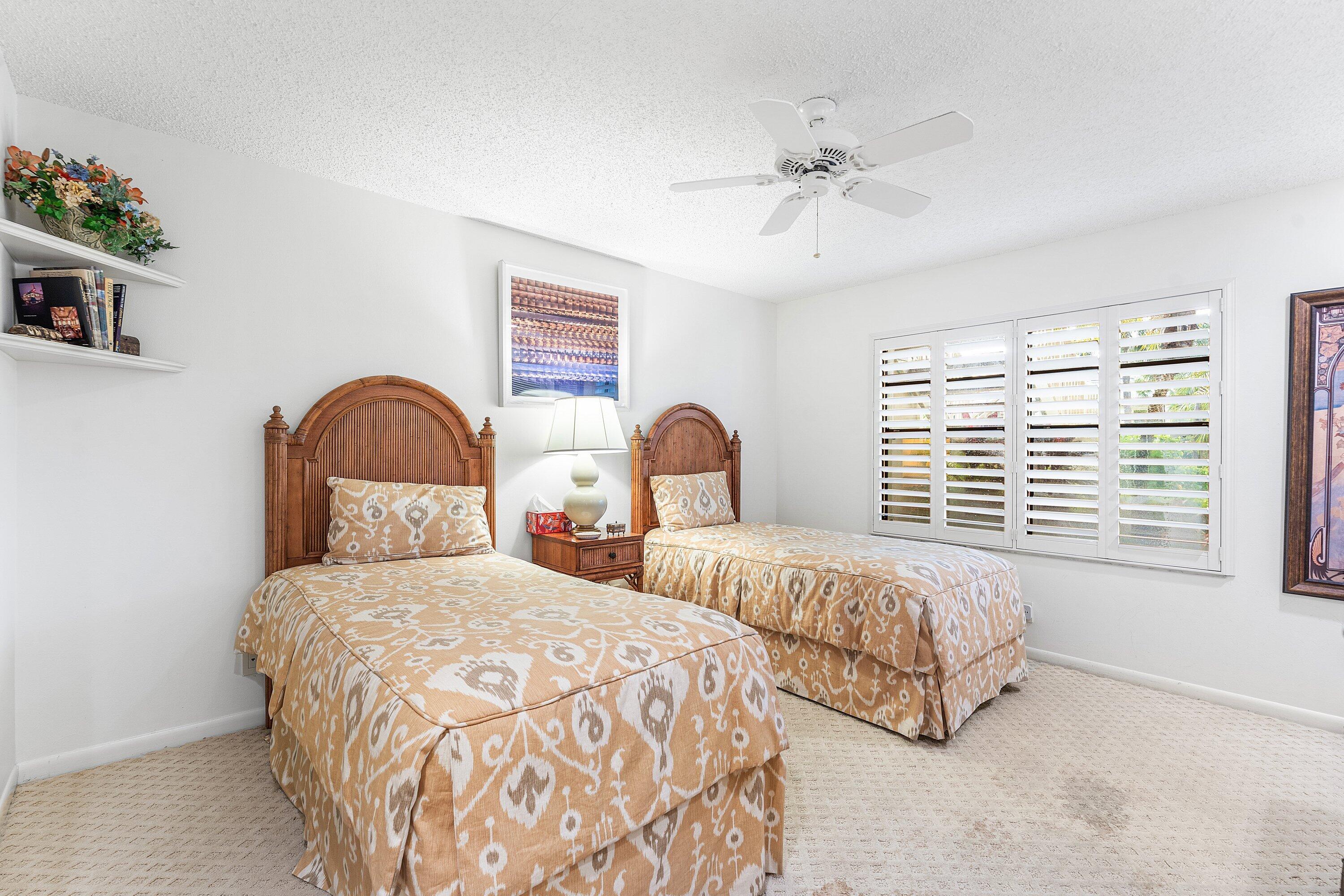 5 Eastgate Drive, Unit A Boynton Beach, FL 33436 - Photo 24 of 49 a bedroom with two beds and a window
