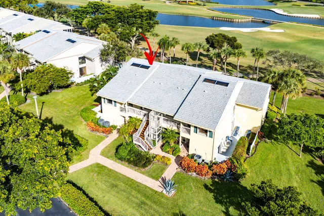 an aerial view of residential houses with outdoor space and trees
