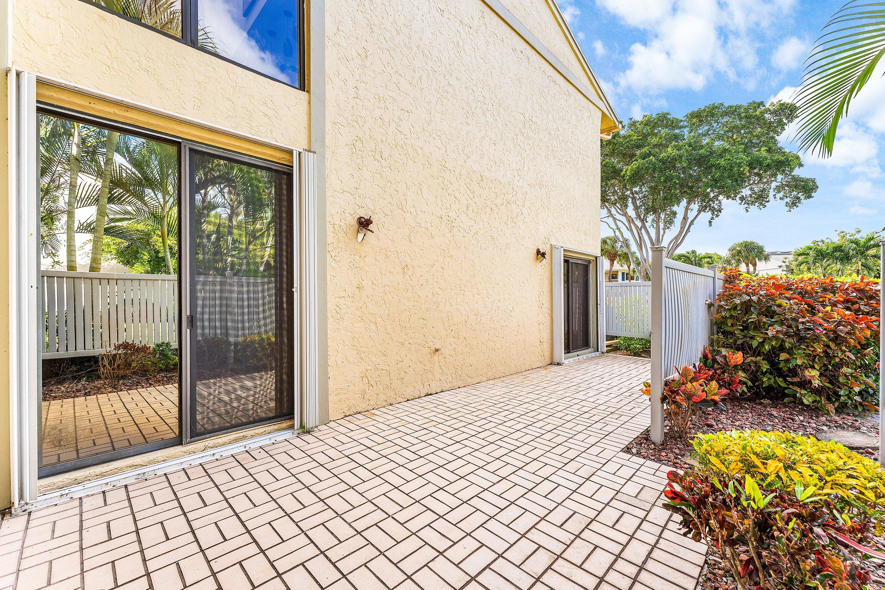 5 Eastgate Drive, Unit A Boynton Beach, FL 33436 - Photo 34 of 49 a bedroom with a bed and a potted plant