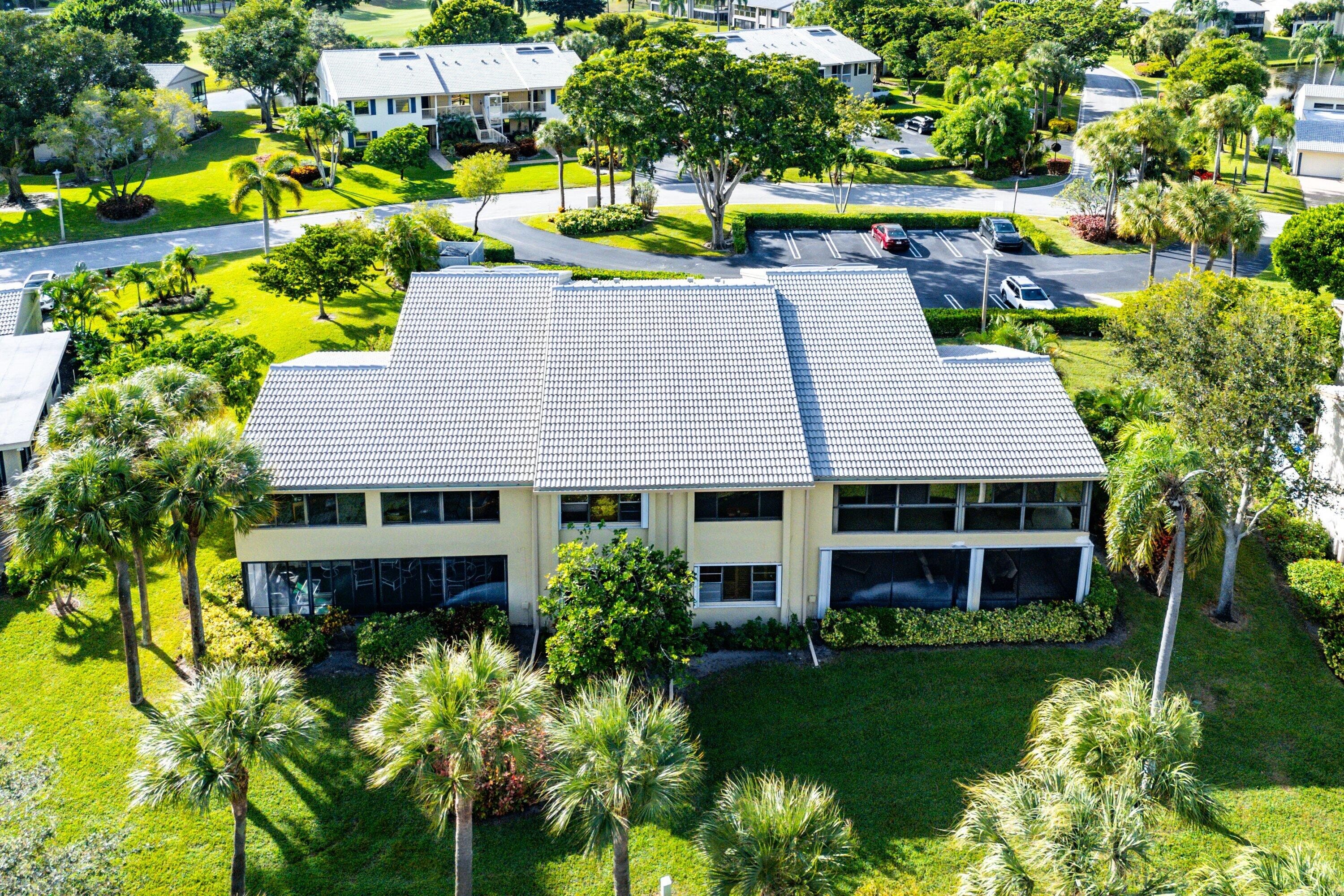 5 Eastgate Drive, Unit A Boynton Beach, FL 33436 - Photo 38 of 49 a aerial view of a house with a yard table and chairs