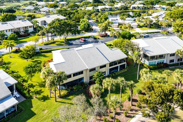 an aerial view of a house with a yard swimming pool and outdoor seating