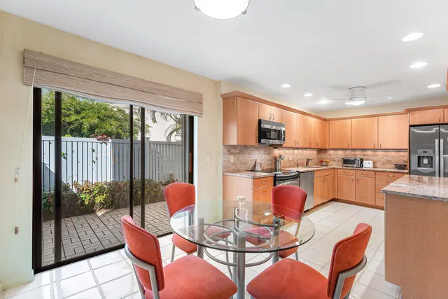 a dining room with furniture a kitchen view and a faucet