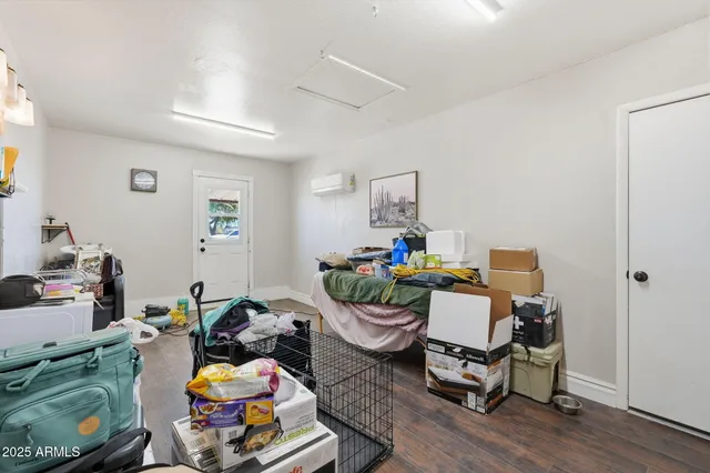 a bedroom with furniture and a wooden floor