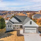 an aerial view of residential houses with city view
