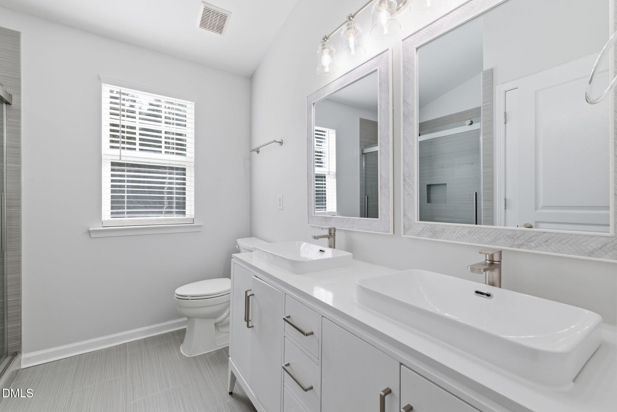 5003 Celtic Court Raleigh, NC 27612 - Photo 27 of 45 a bathroom with a sink double vanity and a mirror