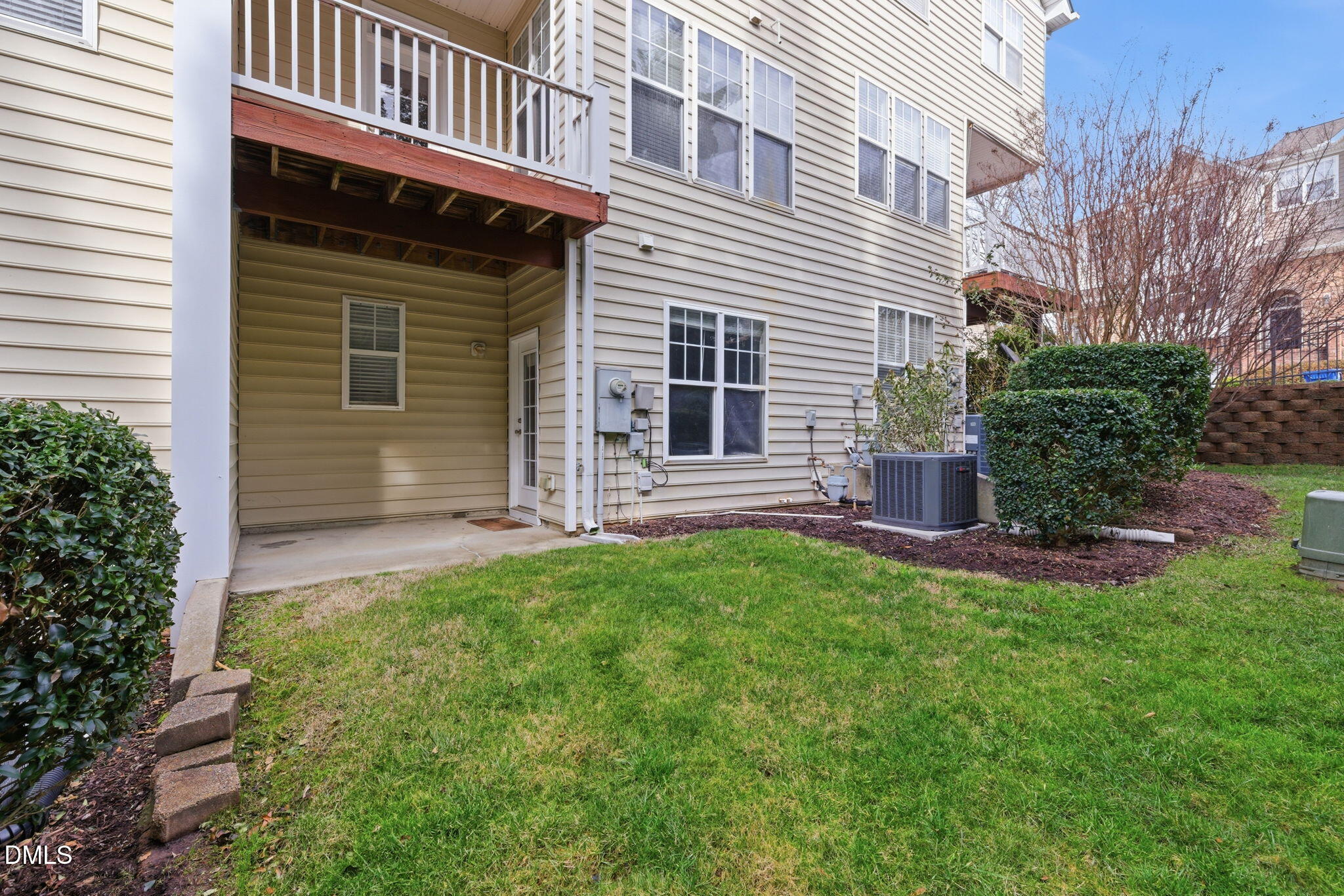 5003 Celtic Court Raleigh, NC 27612 - Photo 43 of 45 a view of a house with brick walls and a yard with plants