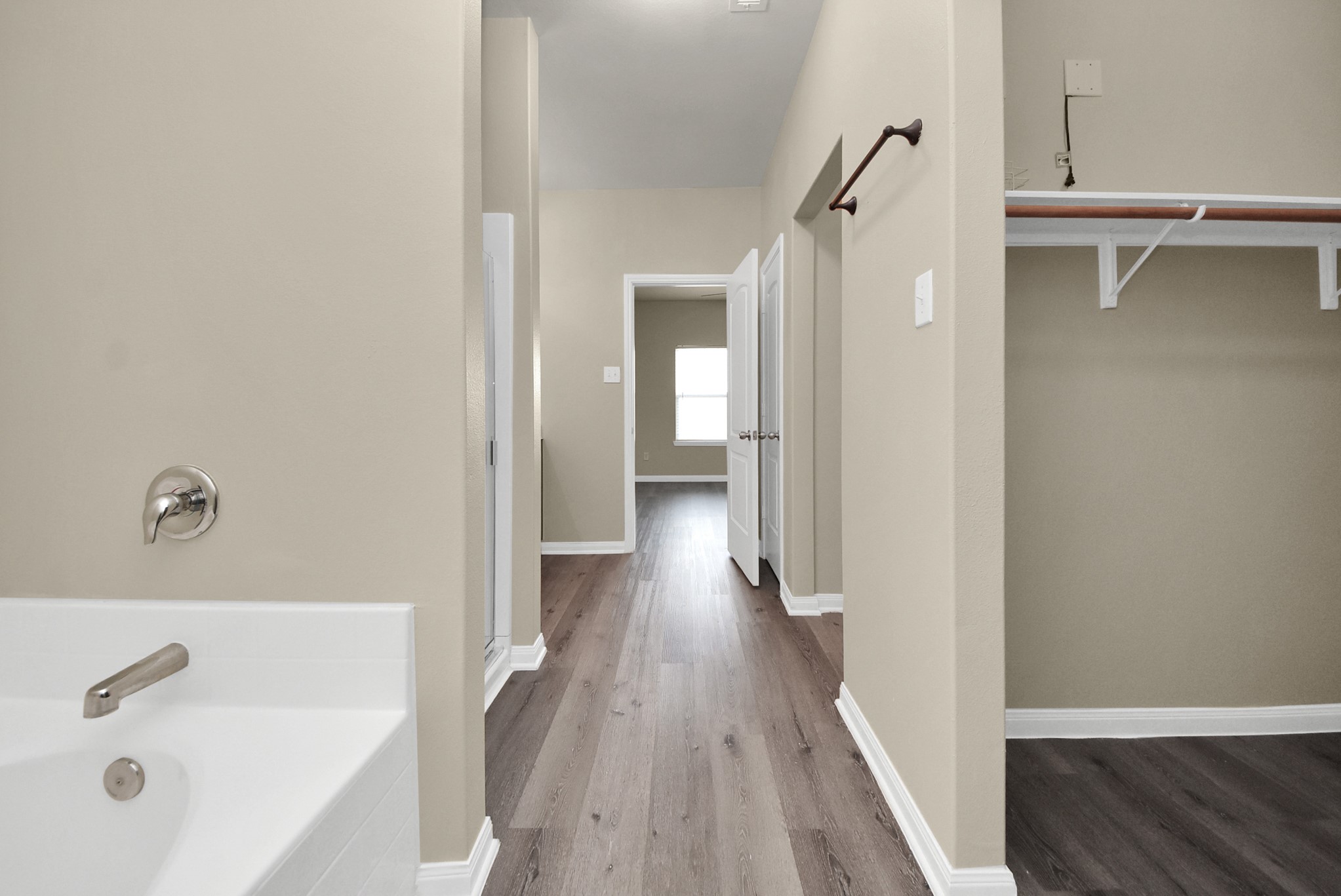 1855 Garnet Breeze Drive Rosharon, TX 77583 - Photo 16 of 40 a view of a hallway with wooden floor and cabinet