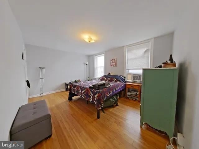 a spacious bedroom with a bed and a dresser