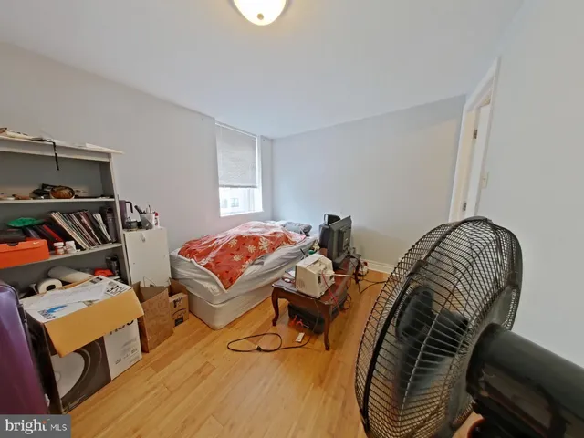 a bedroom with furniture and a wooden floor