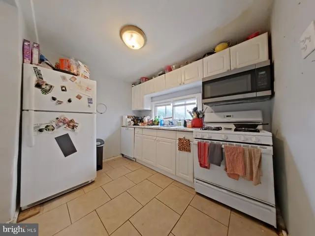 a kitchen with stainless steel appliances a refrigerator and a stove