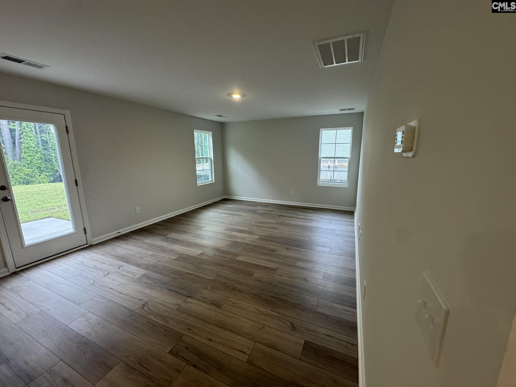 6023 Edgemont Court Elgin, SC 29045 - Photo 3 of 15 an empty room with wooden floor and windows