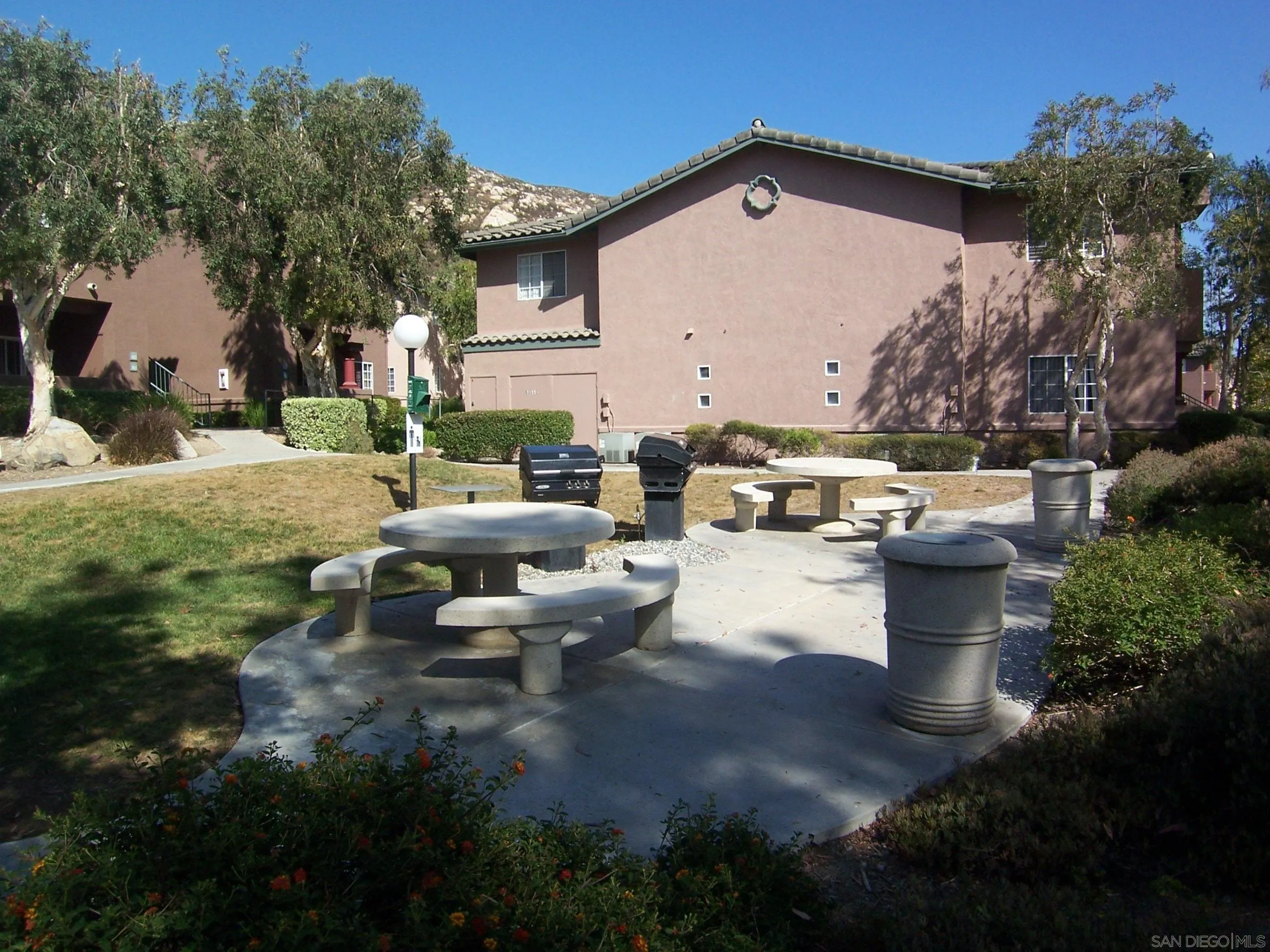 17161 Alva Road, Unit 3125 San Diego, CA 92127 - Photo 3 of 5 a view of a patio with table and chairs with wooden fence