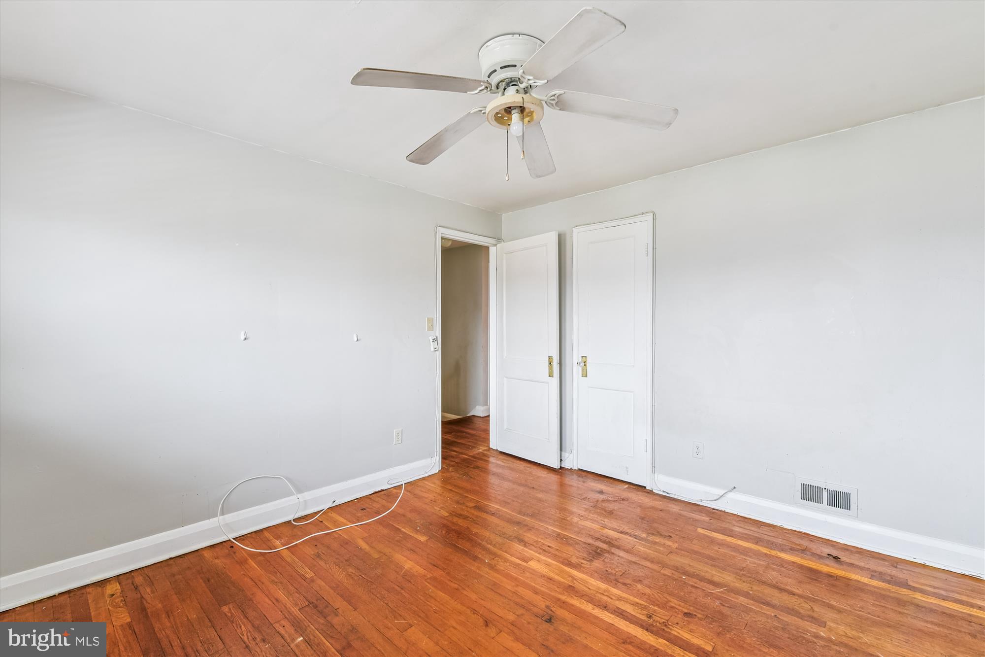 5755 Maplehill Road Baltimore, MD 21239 - Photo 11 of 18 wooden floor in an empty room