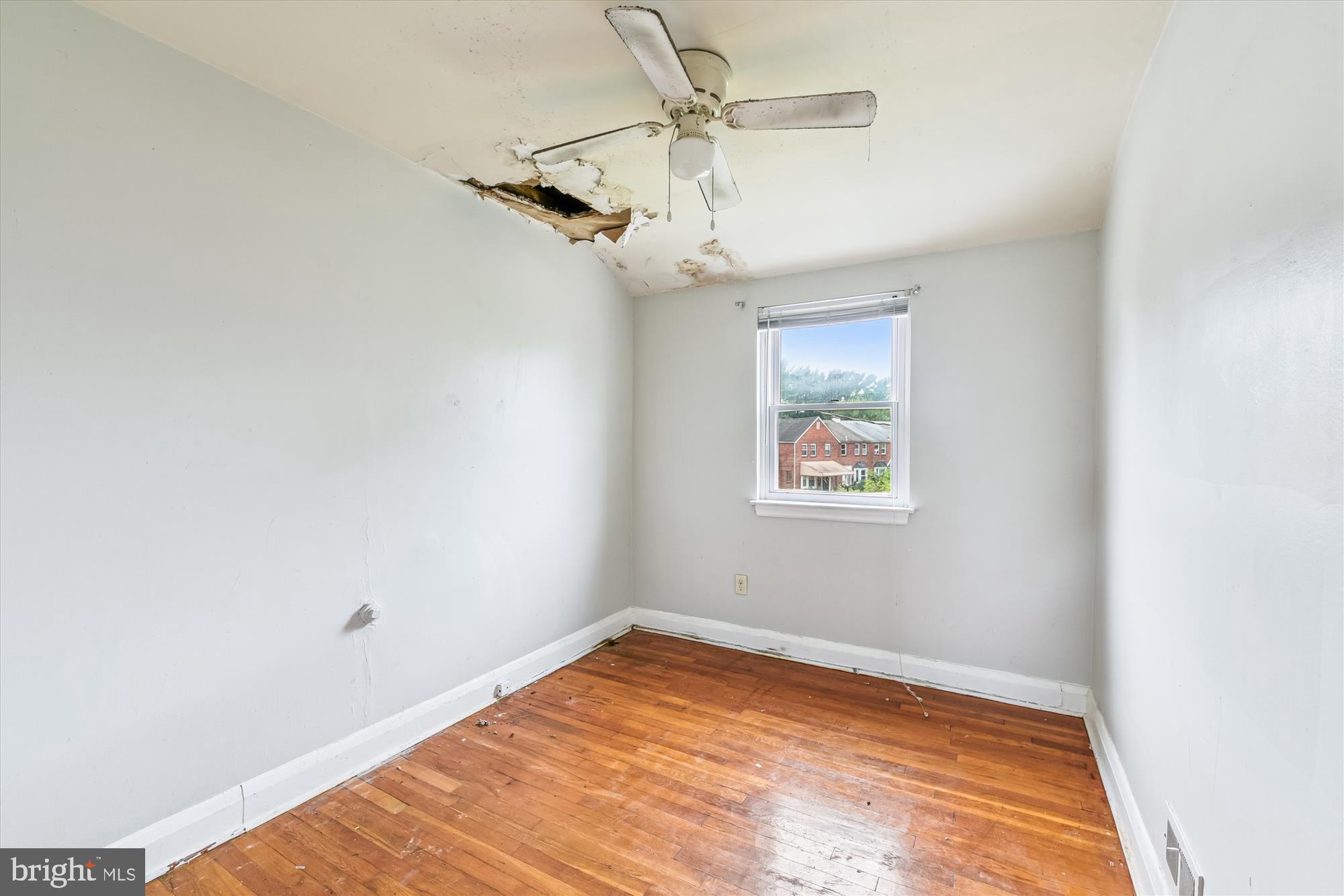 5755 Maplehill Road Baltimore, MD 21239 - Photo 12 of 18 a view of a room with a window and a ceiling fan