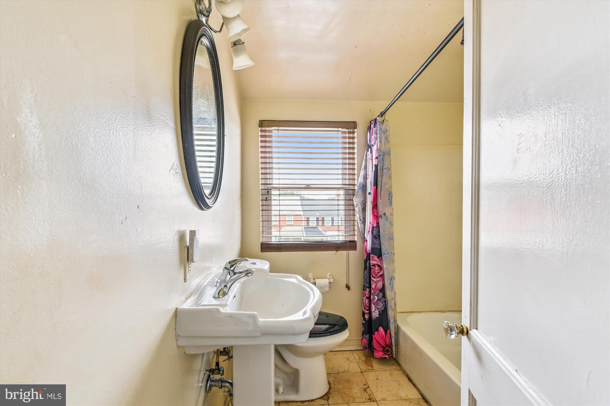 5755 Maplehill Road Baltimore, MD 21239 - Photo 13 of 18 a bathroom with a sink toilet and a mirror