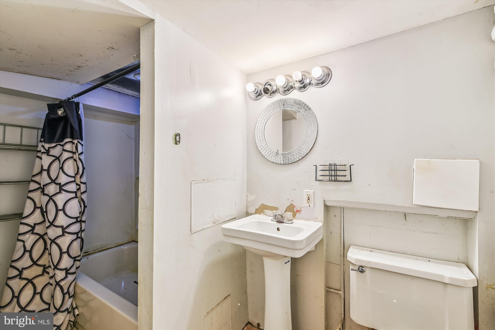 5755 Maplehill Road Baltimore, MD 21239 - Photo 15 of 18 a bathroom with a sink and a mirror