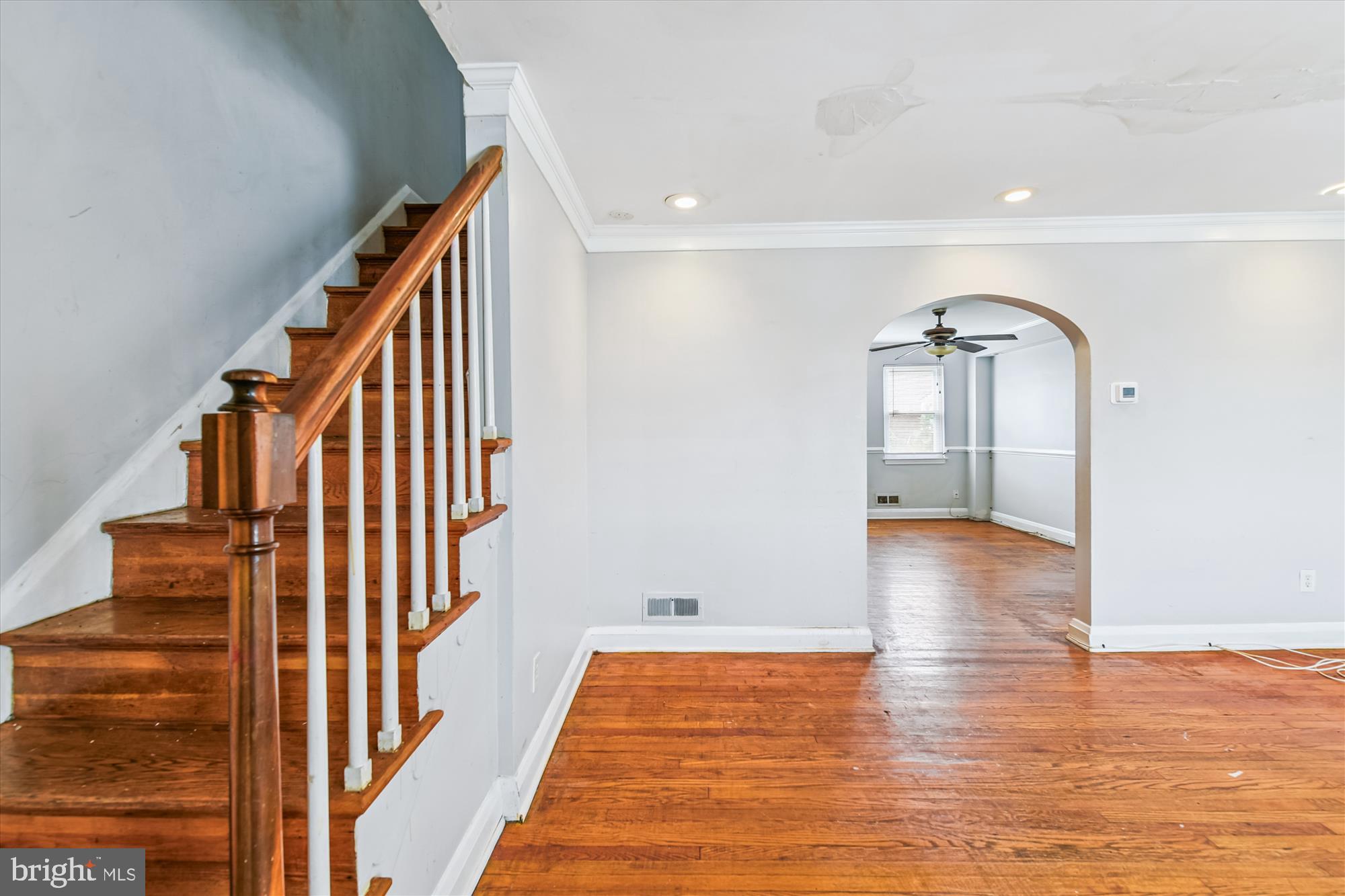 5755 Maplehill Road Baltimore, MD 21239 - Photo 2 of 18 a view of a hallway with wooden floor and staircase