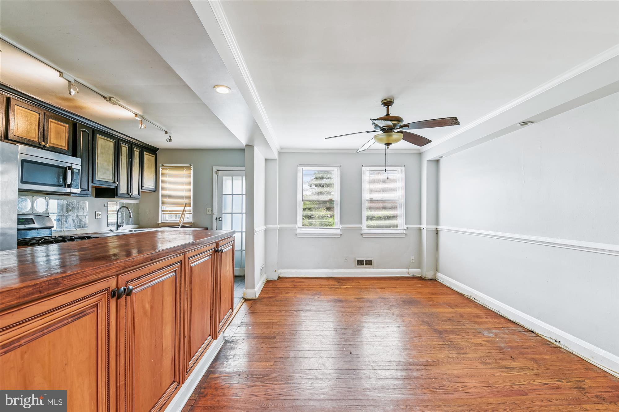 5755 Maplehill Road Baltimore, MD 21239 - Photo 5 of 18 a view of a kitchen with a sink dishwasher and wooden floor
