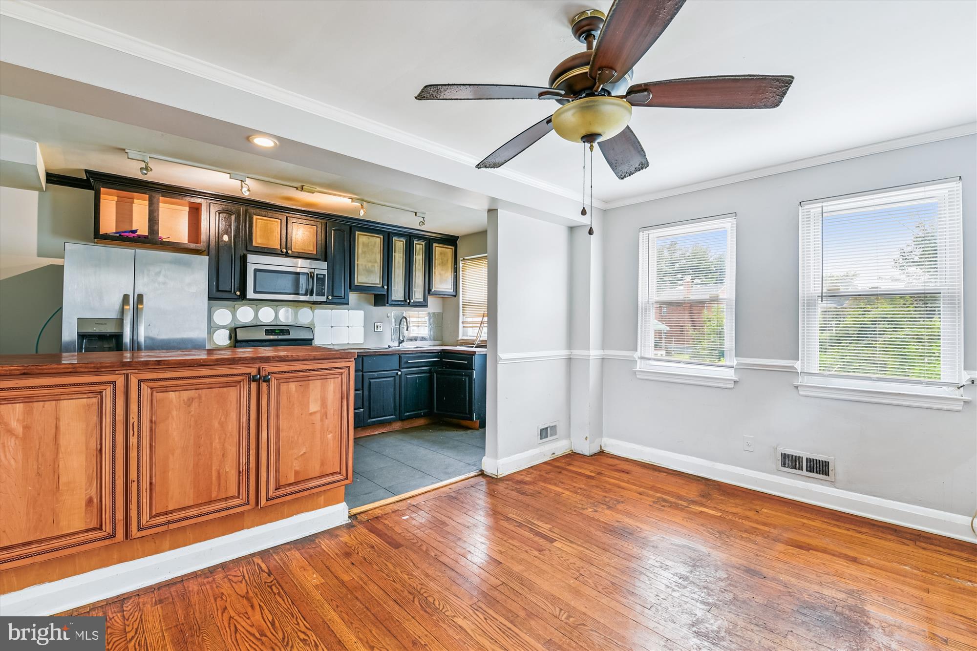 5755 Maplehill Road Baltimore, MD 21239 - Photo 7 of 18 a room with stainless steel appliances kitchen island granite countertop a stove a sink and a microwave