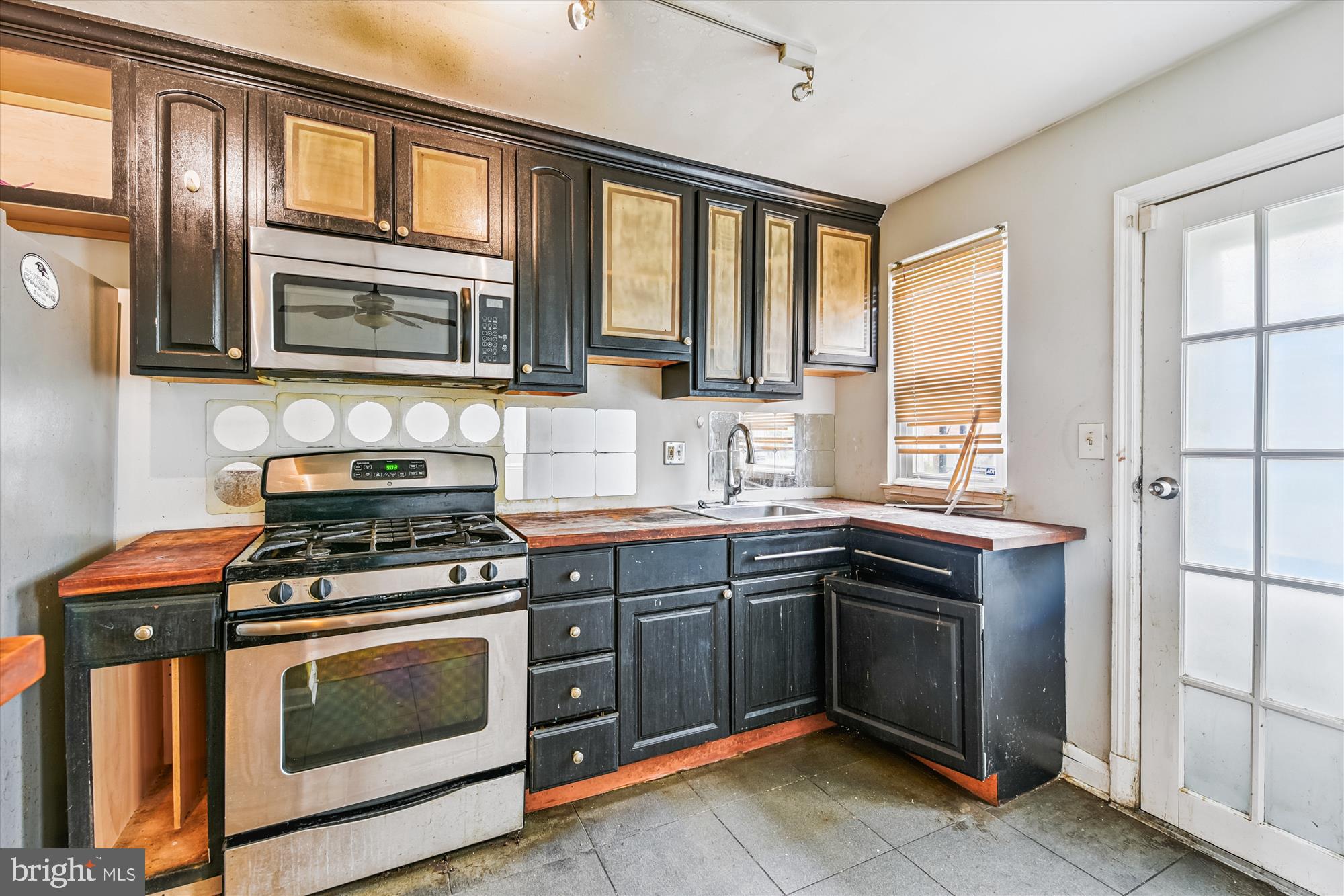 5755 Maplehill Road Baltimore, MD 21239 - Photo 8 of 18 a kitchen with stainless steel appliances granite countertop a stove and a sink
